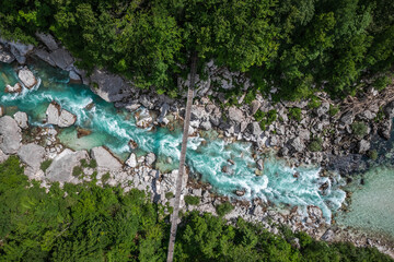Suspension bridge over alpine Soca river in Slovenia