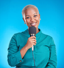 Reporter woman, smile and microphone in studio portrait for news, announcement or talk show by blue...