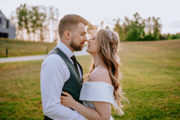The newlyweds look at each other in love in sunset