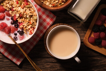 A cup of milk with bowl of oat granola with fresh milk and berries for healthy breakfast. Vegeterian, dieting and weight loss concept.