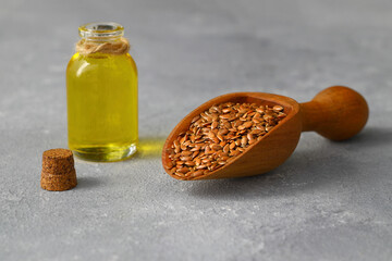Flax seeds. Flaxseed powder in a wooden spoon. Standing on a Wooden background.
