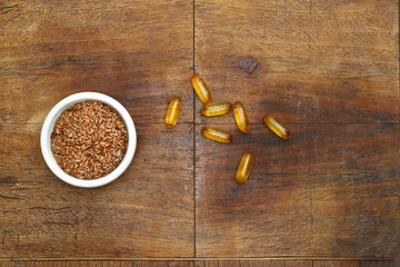Flax seeds. Flaxseed powder in a wooden spoon. Standing on a Wooden background.