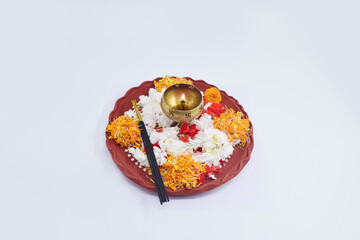 CLAY PUJA THALI WITH FLOWER PETALS,DIYA ISOLATED ON WHITE BACKGROUND.