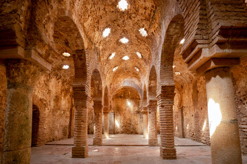 Hamman-type Arab medieval baths in the city of Ronda, Malaga, Spain, with three naves and skylights on the star-shaped ceiling