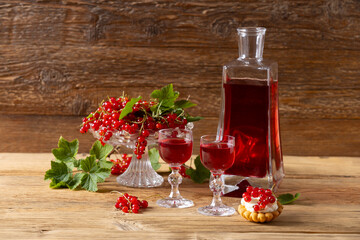 Delicious homemade currant liqueur. Served in a glass and carafe. Served with currant cake.