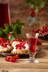 Delicious homemade currant liqueur. Served in a glass and carafe. Served with currant cake.