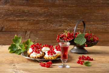 Delicious homemade currant liqueur. Served in a glass and carafe. Served with currant cake.