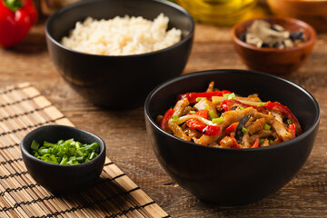 Pork chop with peppers, mushrooms and bamboo. Served with rice.