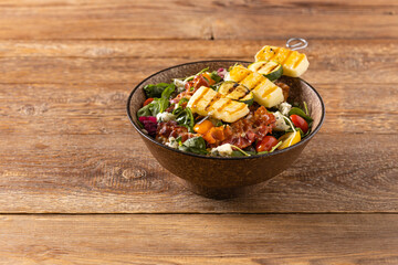Delicious salad added to grilled dishes, with bacon and halloumi cheese.