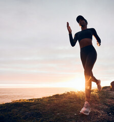 Running, sunrise and woman on mountain by ocean for exercise, marathon training and fitness....