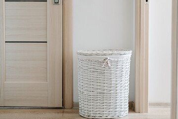 White wicker laundry basket at home. High quality photo
