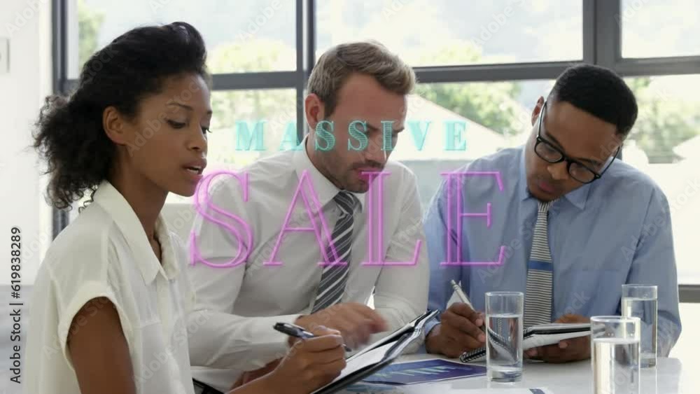 Poster animation of massive sale text over diverse colleague discussing project and writing notes in office