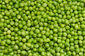 Fototapeta na wymiar Background of fresh organic sweet green peas, pea grains close-up, top view.