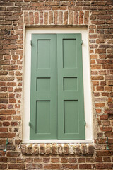 Close up of the color windows of a colonial era home in Charleston, South Carolina