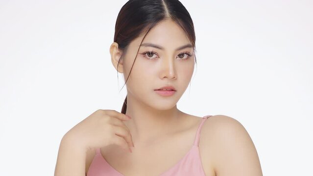 Slow motion shot Close up face of young beautiful young Asian woman with healthy and fresh skin on isolated white background.