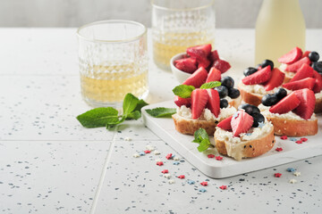 American flag sandwich with strawberries, blueberries, whipped sweet cream, soft cheese on toast bread. 4th of July American Independence Day food. Independence or Patriotic Day breakfast idea Mock up