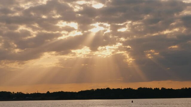 Beautiful landscape of a cloudy sky at sunset and sunbeams breaking through squale clouds