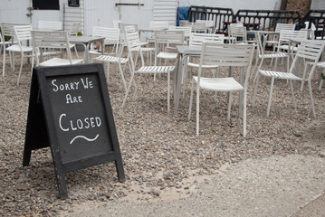 Sorry we are closed sign outside a coffee shop