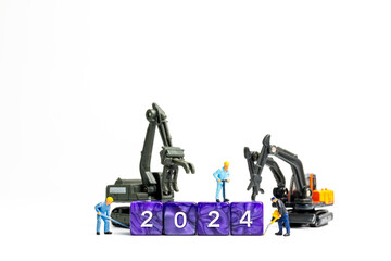 Miniature people , Worker team flips a block with the number 2024, On a white background