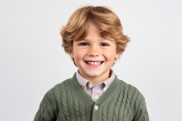 Portrait of a smiling little boy looking at camera over white background