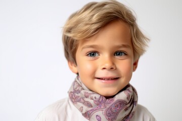 Fototapeta premium Portrait of a cute little boy with blond hair on white background