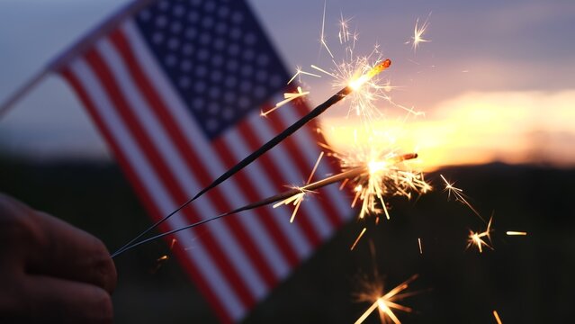 Happy Independence Day July 4th, Labor Day. Hand holding sparklers fireworks celebration fourth of July, 4th of July with America flag background. Concept Holiday, Freedom, Memorial, Veterans Day