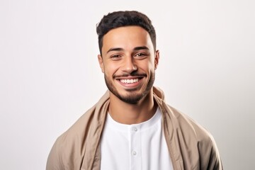 Fototapeta premium Portrait of a handsome young man smiling at the camera on a white background