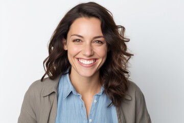 Portrait of smiling businesswoman looking at camera over white background.