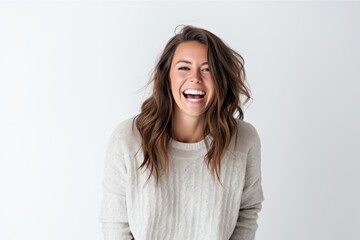 Portrait of a happy young woman laughing and looking at camera over white background