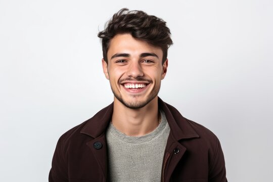 Portrait of a happy young man smiling at the camera on a white background