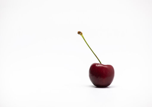 Single cherry isolated on a white background.