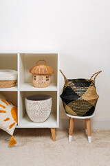 White shelving with  various baskets. Seagrass Belly basket , Cloth, and wicker  baskets for...