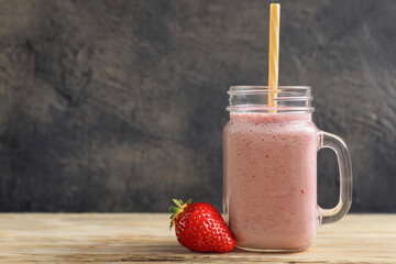 Fruit smoothie from fresh strawberries, dark background