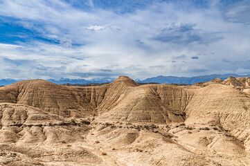 Fototapeta na wymiar Blue sky over sandy canyons. Amazing geological formations.