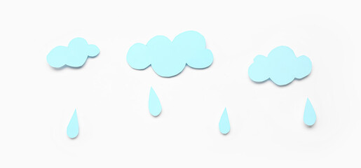 Paper clouds with rain drops on white background. Weather forecast concept