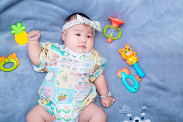 baby boy in floral dress,little baby girl six months old in a cute outfit and a bow on her head