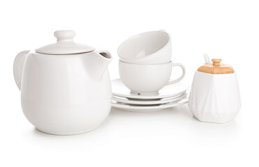 Ceramic teapot with cups, saucers and sugar bowl on white background