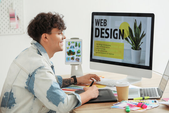 Male graphic designer working at table in office