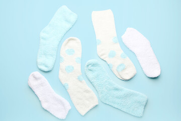 Set of warm socks on color background