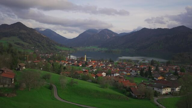 View of mountains and mountain lake in summer. Beautiful town of Schliersee in Bavaria, Germany, Europe. Lake Schliersee in bavarian mountain range. Upper Bayern. Panarama auf den Schliersee. 