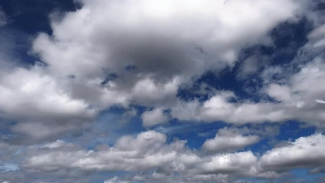 Fluffy white clouds flowing in the blue sky. Cumulus cloud. Cloudscape