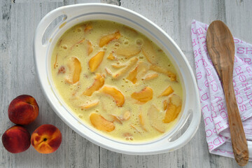 Making French Dessert Peach Clafoutis or Clafouti - unbaked