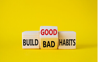 Build Good or Bad Habits symbol. Wooden cubes with words Build Bad Habits vs Build good Habits. Beautiful yellow background. Business concept. Copy space