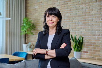 Portrait of mature business confident woman in office