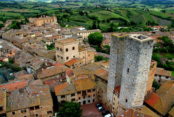 Top view of the historic part of the city with the medieval towers in San Gimignano, near Siena, in Tuscany region of Italy - obrazy, fototapety, plakaty