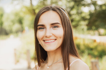 Fototapeta premium Beautiful fashionable woman outdoors. Young female model wearing dress posing in summer park.
