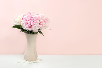 Floral composition with peony flowers in a vase on a light background, summer banner, greeting card for wedding, holiday, birthday, template for design, selective focus