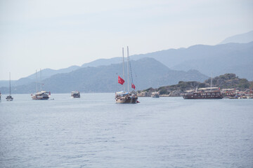 Fototapeta na wymiar Beautiful view of the sea bay and pleasure yachts on a sunny summer day, in Turkey