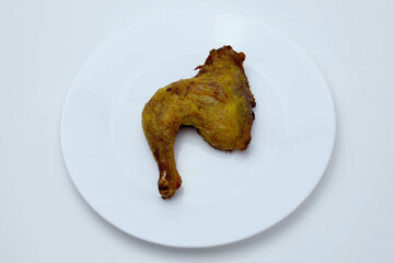 One fried chicken on a plate with white background