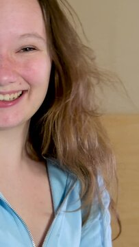 indescribable joy of teenager girl laughing with her mouth open jumping dancing on the bed in the room in the bedroom Cheerful teenager 